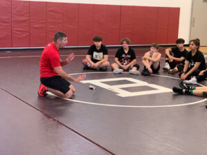 Rhinoh wrestling's Coach Tomeo instructing wrestlers